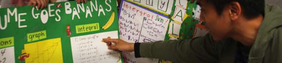 student pointing to pinboard