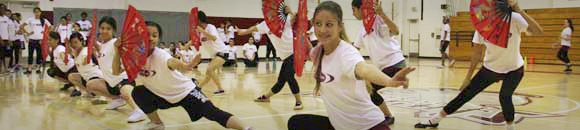 students traditional dancing with flags
